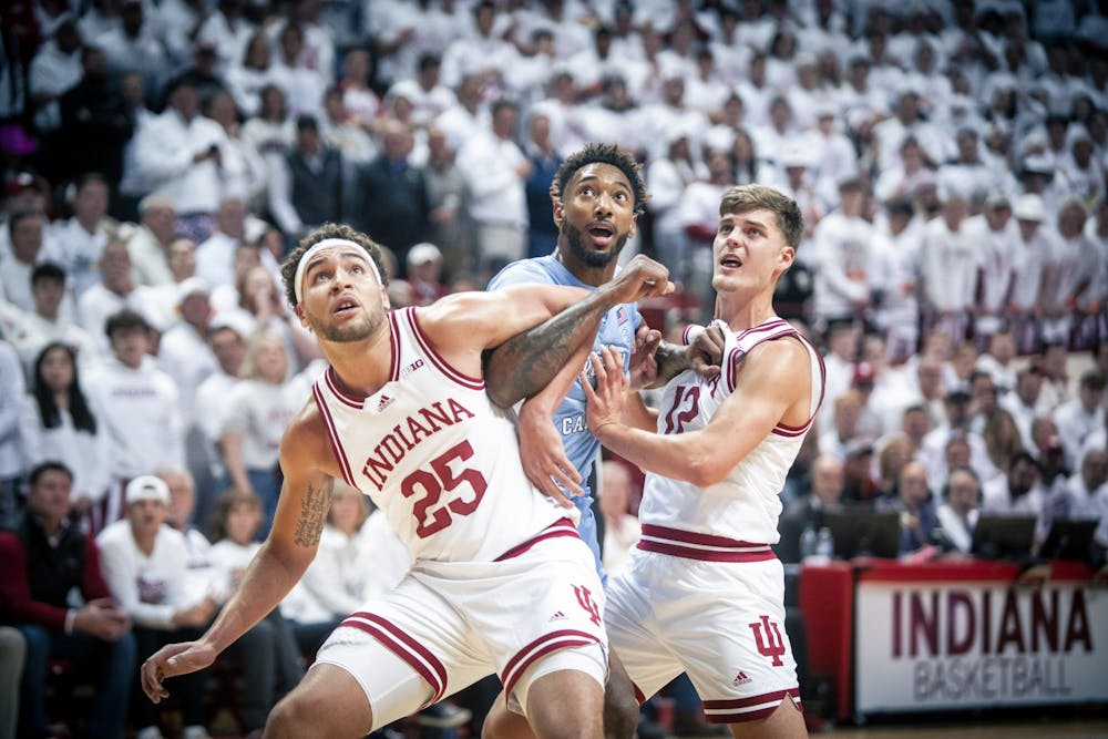 <p>Graduate forward Race Thompson guards and graduate guard Miller Kopp look to grab a rebound Nov. 30, 2022, at Simon Skjodt Assembly Hall in Bloomington, Indiana. Indiana lost to Rutgers 63-48 on Saturday.</p>