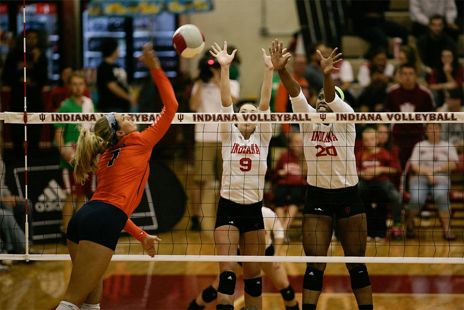 Junior setter Megan Tallman and senior blocker Awele Nwaeze block a spike from an Illinois player. The Hoosiers fell to the Fighting Illini 3-0 on Friday at University Gym. 