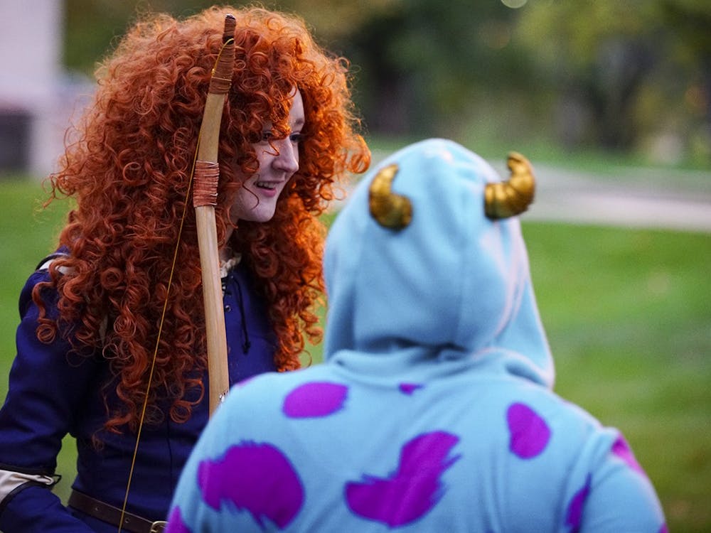 Then-freshmen Kiara Morris portrays Sulley from Monsters, Inc., while Taryn Brandl dresses as Merida from the movie Brave during Central’s Creepy Carnival on Oct. 28, 2017, outside of Teter Quadrangle. It is important to be proactive and alert to stay safe during Halloween festivities.