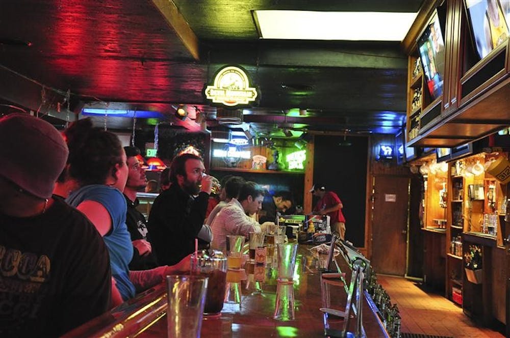 Patrons enjoy a drink while watching Indiana and Minnesota play Tuesday evening at Yogi's.