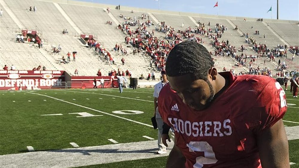 Senior running back Marcus Thigpen walks off the field following Indiana's 37-34 loss to Central Michigan on Saturday at Memorial Stadium.  Thigpen ran for 109 yards and two touchdowns.