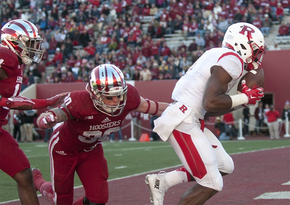 Safety Chase Dutra dives to tackle Rutger's wide receiver Leonte Carroo as he scores on Oct. 17 at Memorial Stadium. The Hoosiers lost, 52-55.