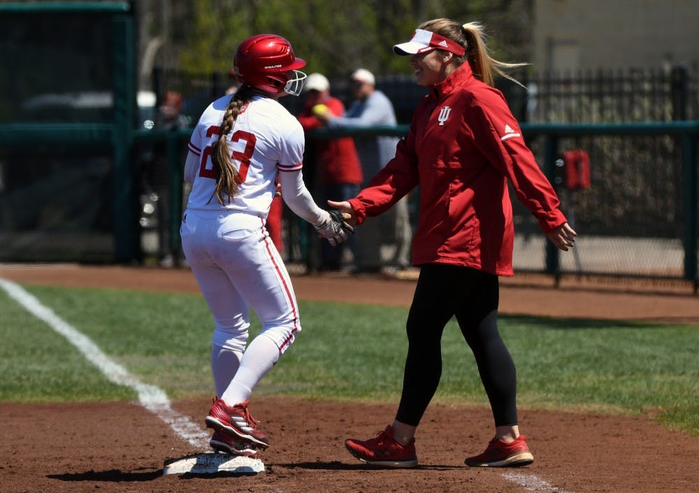<p>Then-sophomore utility player Gabbi Jenkins high-fives assistant coach Kendall Fearn during a game against Michigan in the 2018 season. Jenkins had three hits against Boston College on Feb. 17 to give IU a win in the 2018 ACC/Big Ten Challenge.&nbsp;</p>