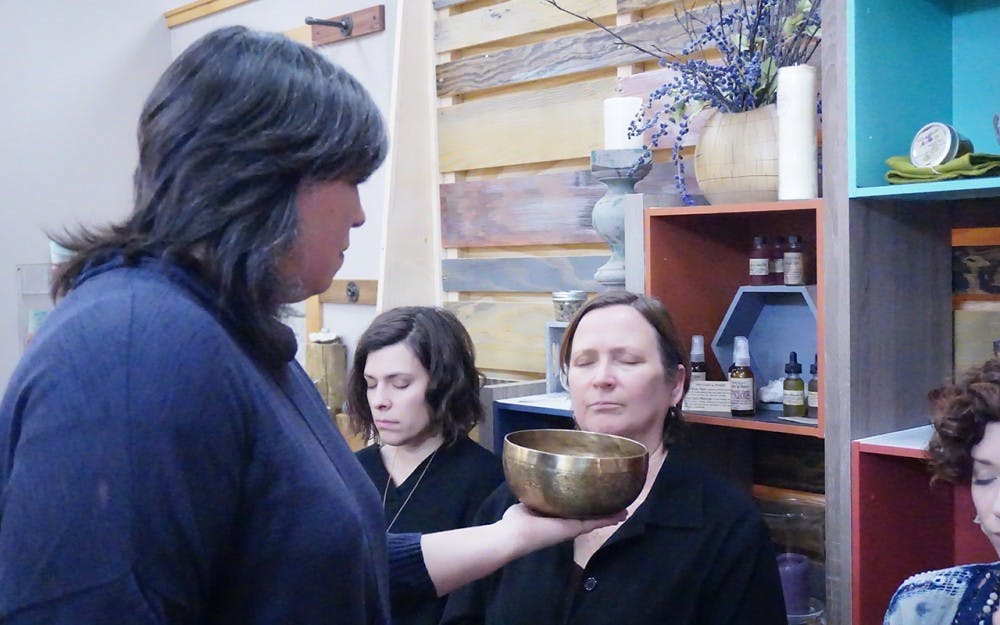 Acutonics Practitioner&nbsp;Carol Cobine gives a lesson on healing through sound and vibrations at&nbsp;Inner Light Bloomington Thursday evening. Cobine&nbsp;soothes her students with a Tibetan bowl.