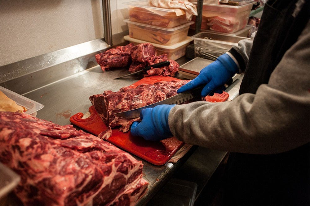 Butcher Prospero Sotelo prepares meat that will later be served at Texas Roadhouse in the evening. Sotelo starts his days at 5 a.m., cutting steaks and listening to music in the meat locker. He has won numerous national titles for his butcher skills and will travel to Florida this weekend to compete for the title of Meat-Cutter of the Year at the National Meat Cutting Challenge, a title that he last won in 2005.