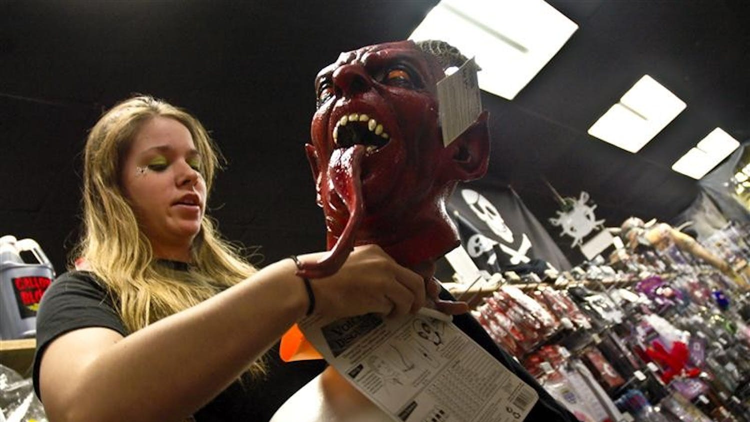 Kiersten Thomson, a IU Sophomore majoring in Criminal Justice, carefully sorts through accessories for her mask on Monday night at Campus Costume, 2530 E. 10th St.