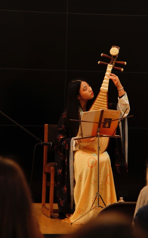 Sophomore&nbsp;Zixuan Wang, vice president of public relations for the Chinese Calligraphy Club,&nbsp;plays the traditional pipa instrument as an introduction to the&nbsp;exhibition "Quilts of Southwest China" in the Mathers Museum.&nbsp;&nbsp;