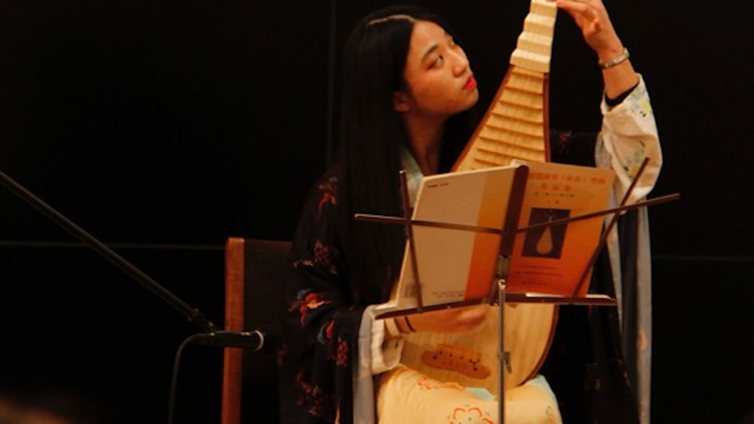 Sophomore&nbsp;Zixuan Wang, vice president of public relations for the Chinese Calligraphy Club,&nbsp;plays the traditional pipa instrument as an introduction to the&nbsp;exhibition "Quilts of Southwest China" in the Mathers Museum.&nbsp;&nbsp;