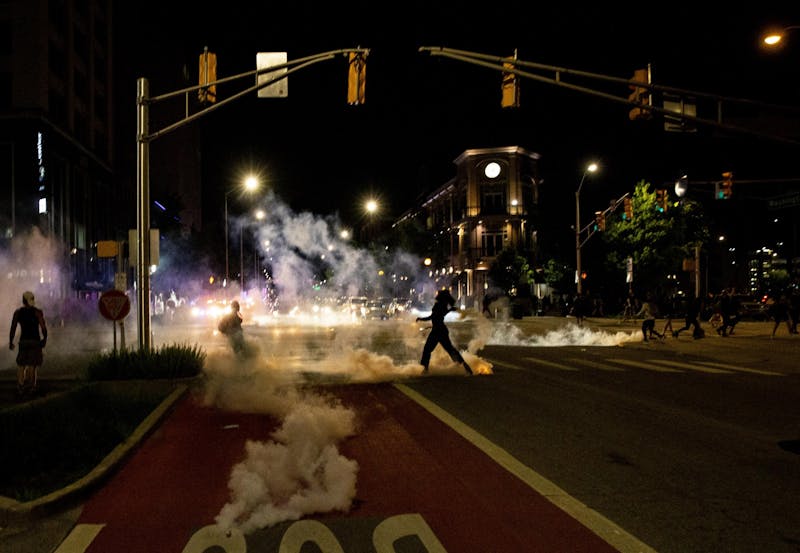 Tear gas creeps up the street May 30 in Indianapolis. Police enforcement used tear gas to break up the protest in response to the police killings of George Floyd in Minneapolis, Breonna Taylor in Louisville, Kentucky, and Dreasjon Reed in Indianapolis.