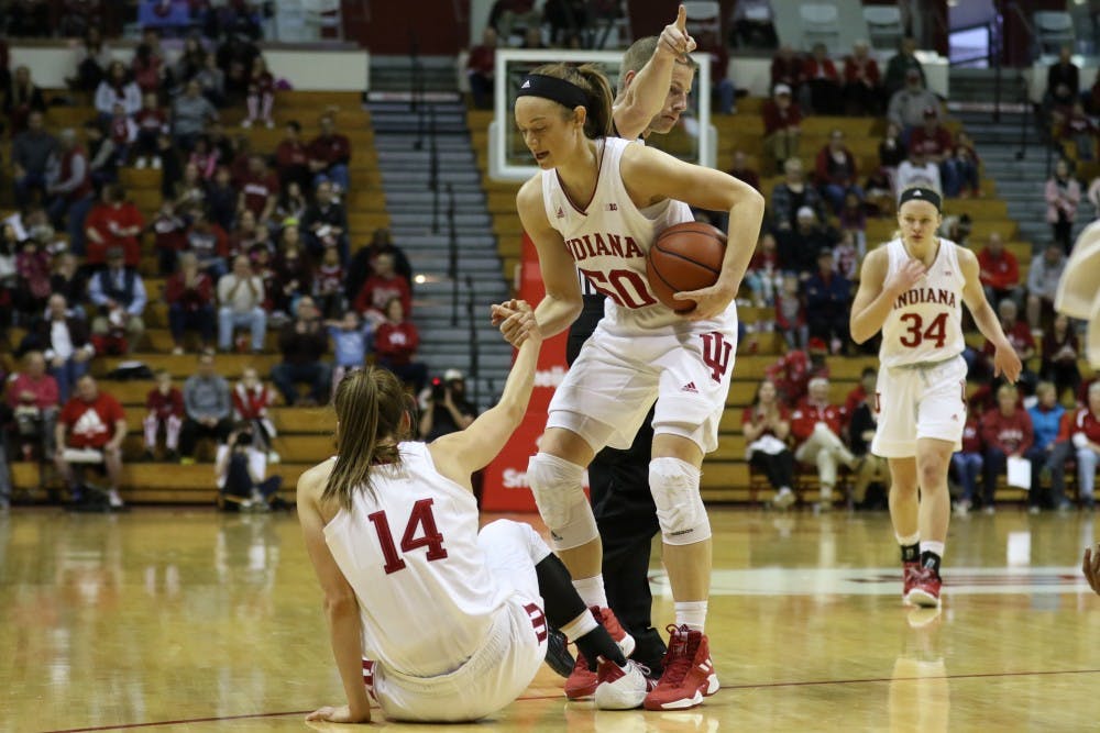 <p>Junior Brenna Wise helps fellow junior Ali Patberg off the ground following a foul during the game against Missouri State on Dec. 9 at Simon Skjodt Assembly Hall.&nbsp;</p>