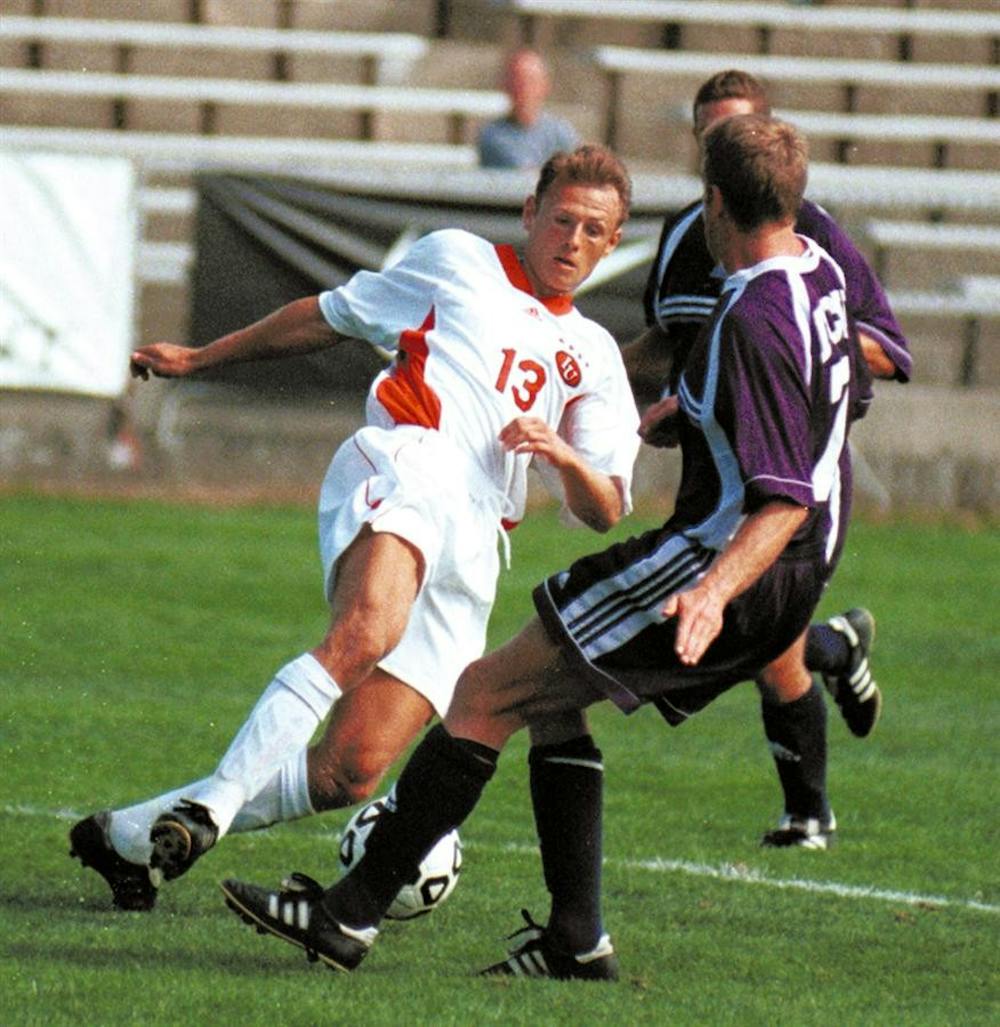 Former senior forward Aleksey Korol splits two Texas Christian University defenders to attempt a shot on goal on Sunday, Sept. 19, 1999 in Indianapolis. Korol was named Big Ten Player of the Year, NSCAA All-America and Soccer America Player of the Year for the 1999 season and joined the Indiana coaching staff in February 2009.