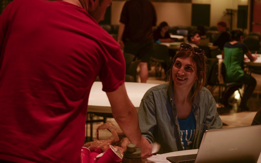 Lexi Heinemann, co-chair of Culture of Care, accepts written responses to sexual education trivia questions Tuesday evening at the Sexual Wellbeing Tuesday event. Culture of Care encourages healthy habits, raises awareness and educates students on wellness topics throughout the week.