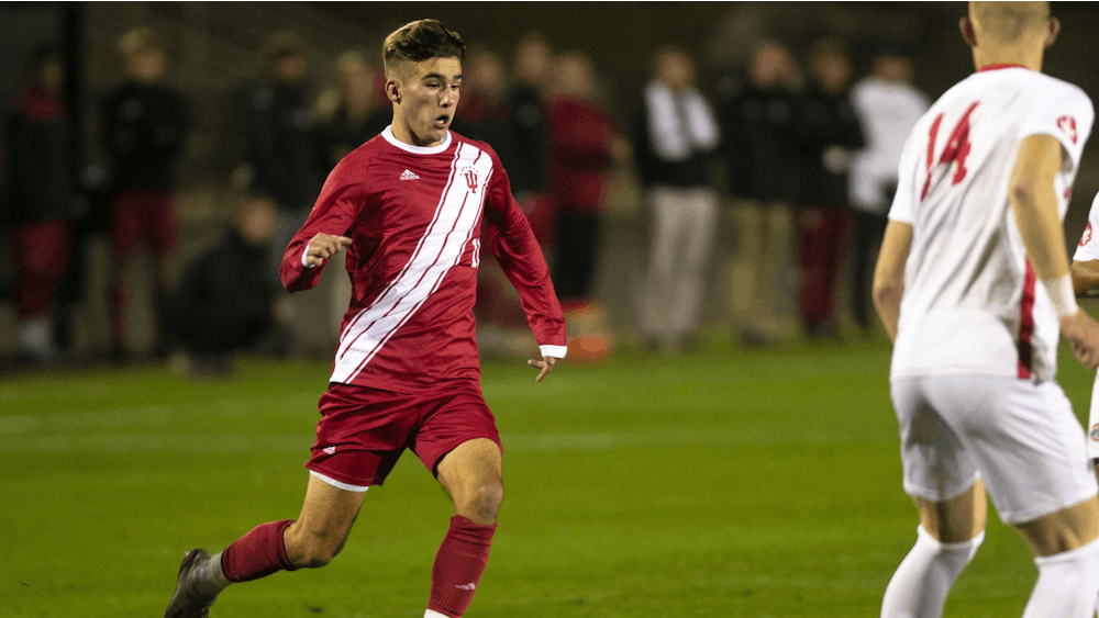 Freshman Joshua Penn dribbles toward the Ohio State defense Oct. 29 at Bill Armstrong Stadium. IU won the Big Ten championship Sunday with a 1-0 victory over Michigan State in East Lansing, Michigan.