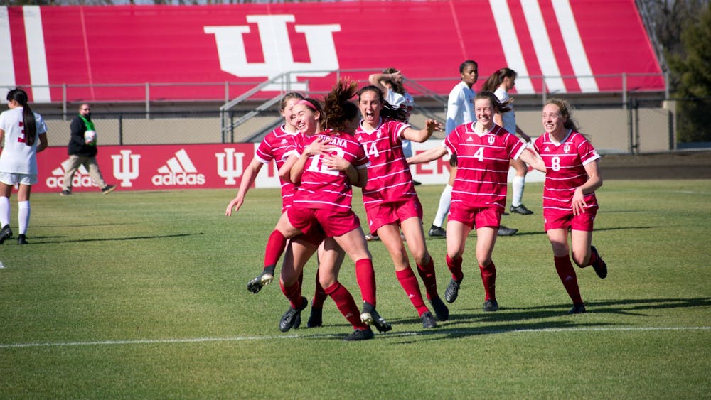 Players on the Indiana women&#x27;s soccer team celebrate Feb. 25, 2021. Indiana lost its final home match to Maryland 0-1 on Thursday. 