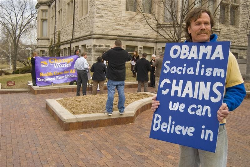 Jim Billingsly, 51, protests as members of the Service Employees International Union speak to students about the possible benefits of universal health care in Indiana, Thursday afternoon on Indiana avenue. 