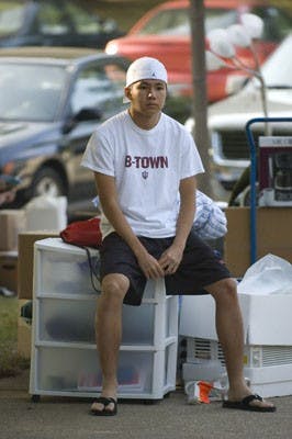 James Brosher 8 IDSFreshman Perryn Ly waits with his belongs as his father parks the car Wednesday morning in front of Read Quad.