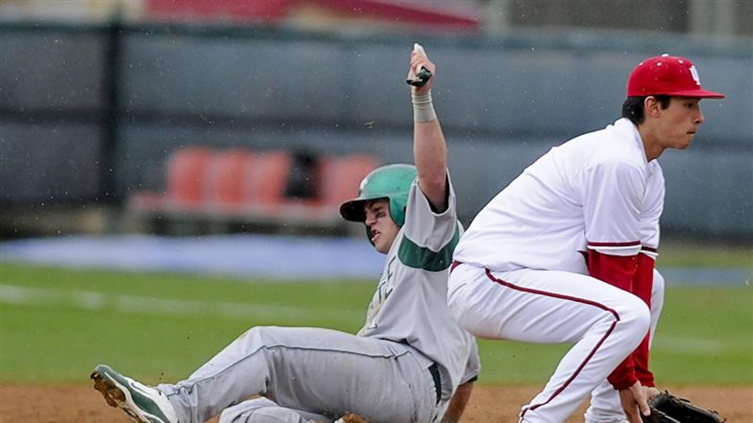 Chicago State's Albert Carpen slides into second in front of junior infielder Jake Dunning on March 31 at Sembower Field. The Hoosiers face Louisville at 4 p.m. today on the road.