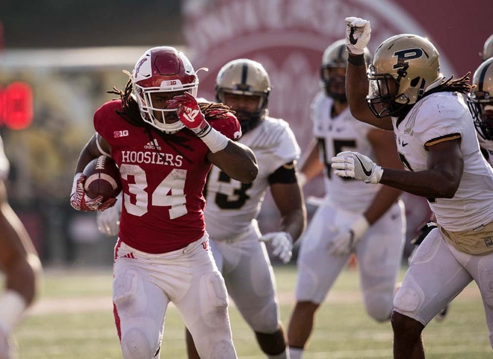 Junior running back Devine Redding runs the ball up the field during the second half against Purdue. IU beat Purdue 26-24 on Saturday for the fourth year in a row.