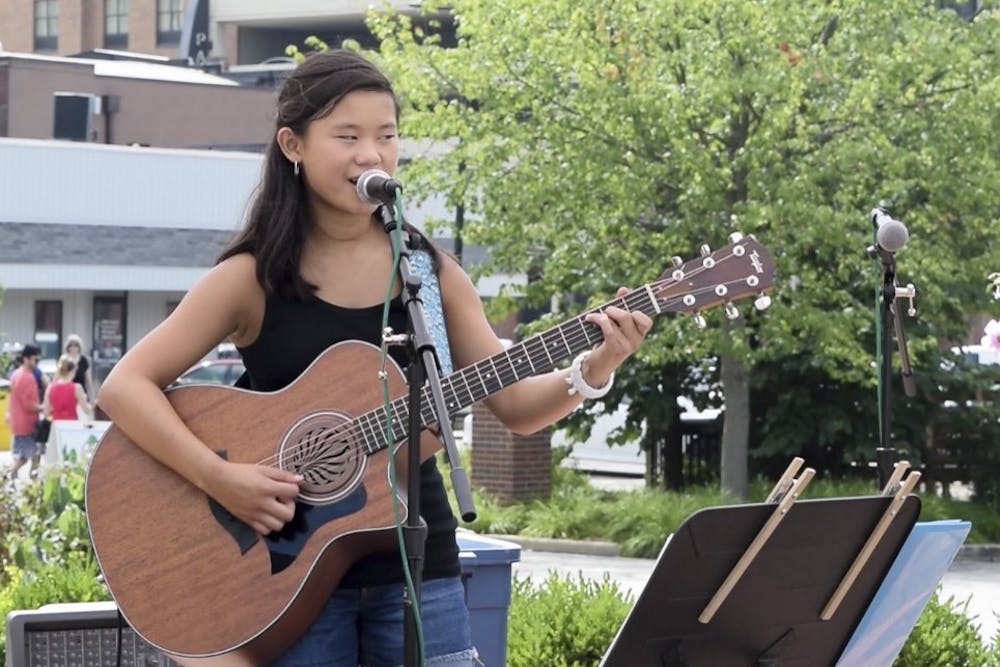 Anna Wrasse performs at the Bloomington Community Farmers' Market on July 23. Wrasse performed publicly for the first time at 11 years old.&nbsp;