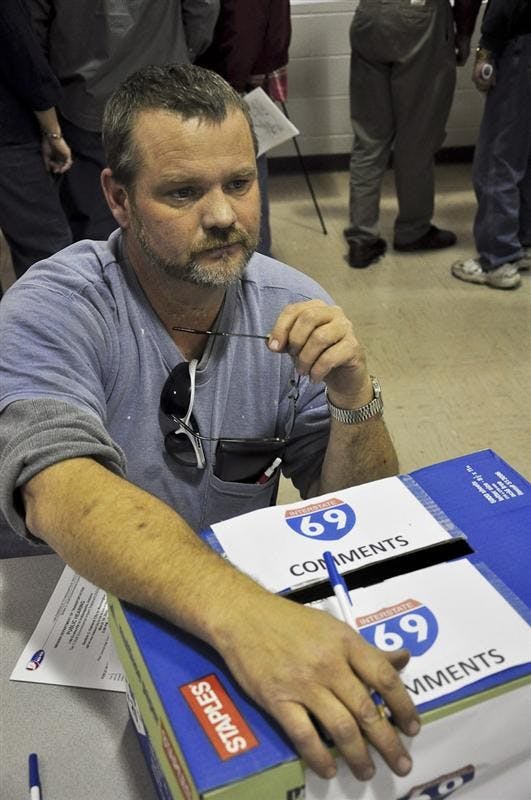 Stan Brewster of Petersburg, Ind. talks with a neighbor about losing land to construction of Section 2 of Interstate 69. The 29-mile stretch of highway will take over 1,800 acres of land from Washington, Ind. to Oakland City, Ind.