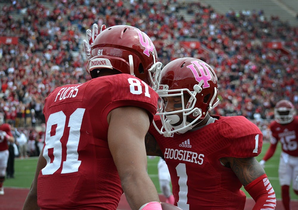 Senior receiver Shane Wynn celebrates with freshman Jordan Fuchs after Wynn scored a touchdown in IU's game against North Texas on Saturday at Memorial Stadium.