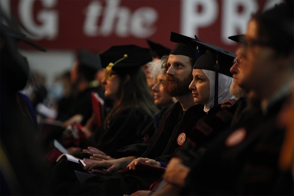 Graduates sit and listen during the commencement speech given by C. David Allis.