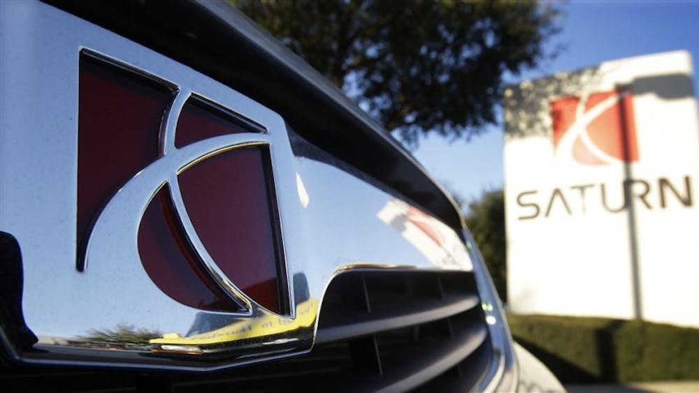 In this Feb. 19, 2009 file photo, the Saturn logo is seen on a car at a dealership in San Antonio.
