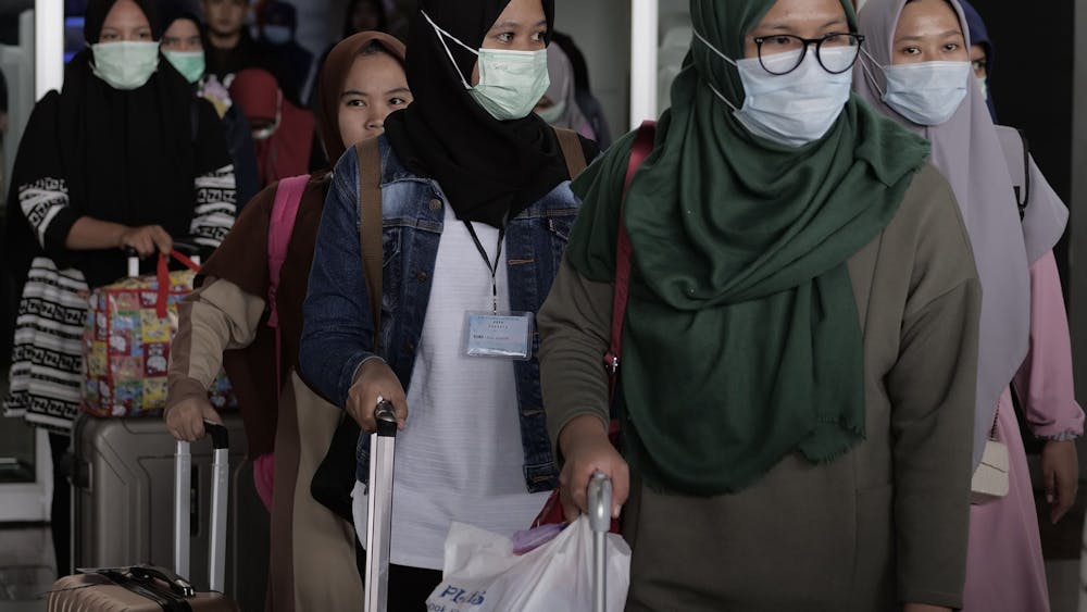 Airline passengers wear face masks Feb. 1 at the airport in Cengkareng, Indonesiaas a precaution to the outbreak of the coronavirus. The U.S. has offered its top public health experts to help China with its coronavirus outbreak, but China has yet to respond.