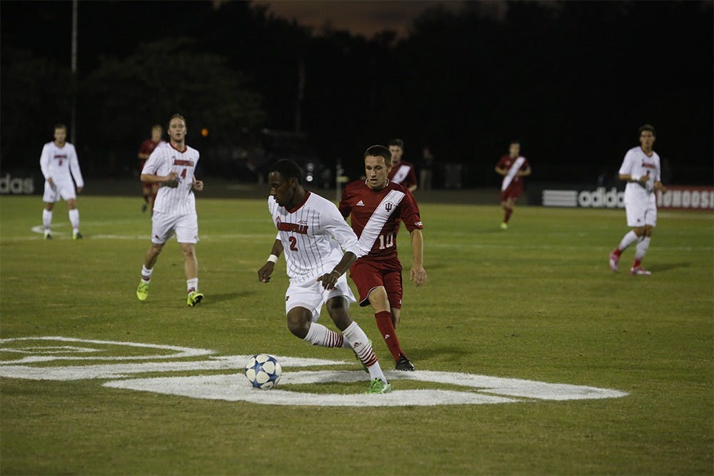 Junior midfielder Tanner Thompson fights for the ball during IU's game against Louisville Tuesday night at the Bill Armstrong Stadium.