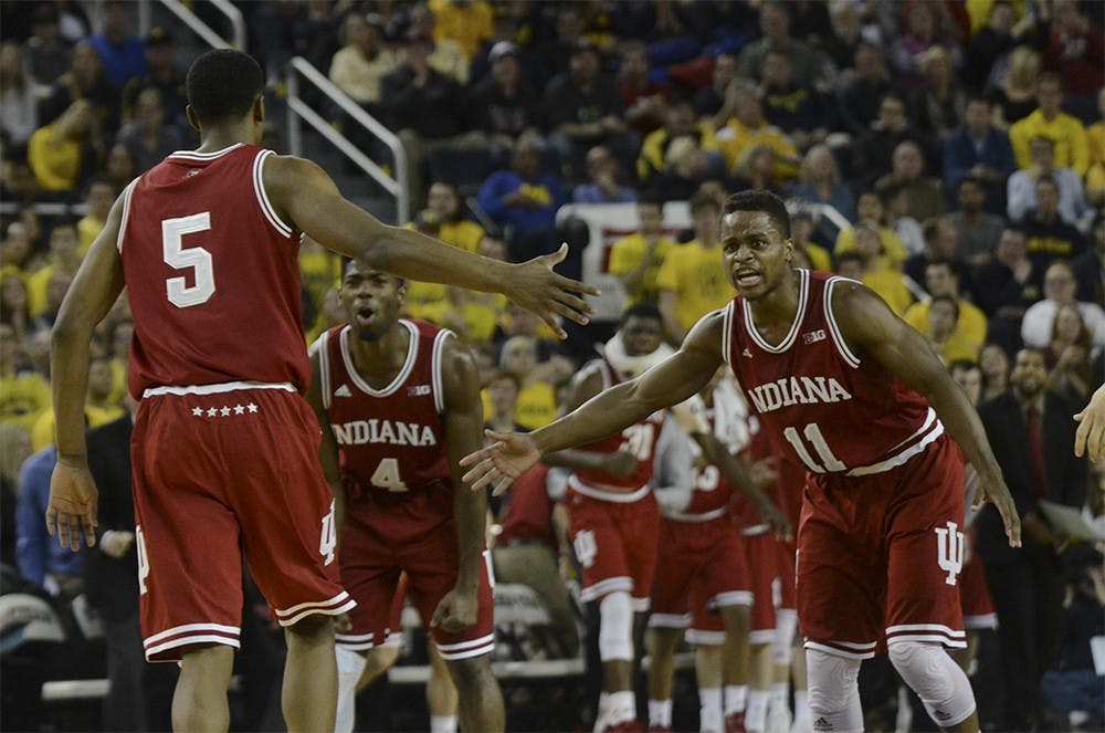 Senior guard Yogi Ferrell (11) high fives junior forward Troy Williams during the game against Michigan on Tuesday at Crisler Center in Ann Arbor, Mich.