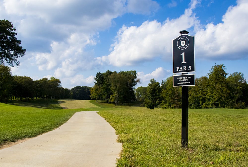 <p>A path runs by the sign for the first hole at the Pfau IU Golf Course. The new course will open to the public June 15.</p>