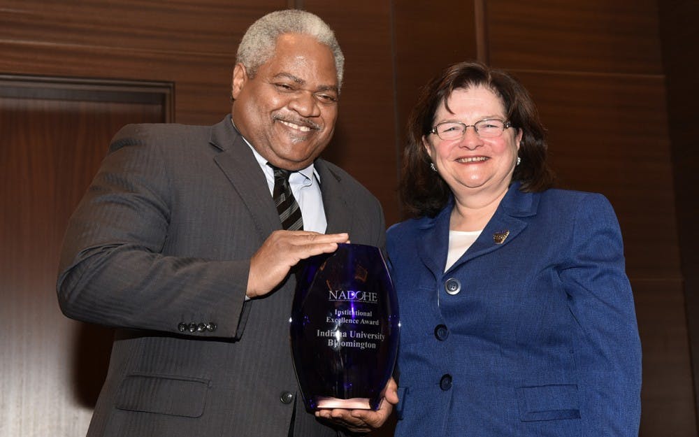 Associate Professor of Business Law&nbsp;Martin McCrory, left, accepts the Institutional Excellence Award from awards chair Carmen Suarez. IU announced that McCrory will resign from his position as&nbsp;associate vice president for the Office of the Vice President for Diversity, Equity and Multicultural Affairs.