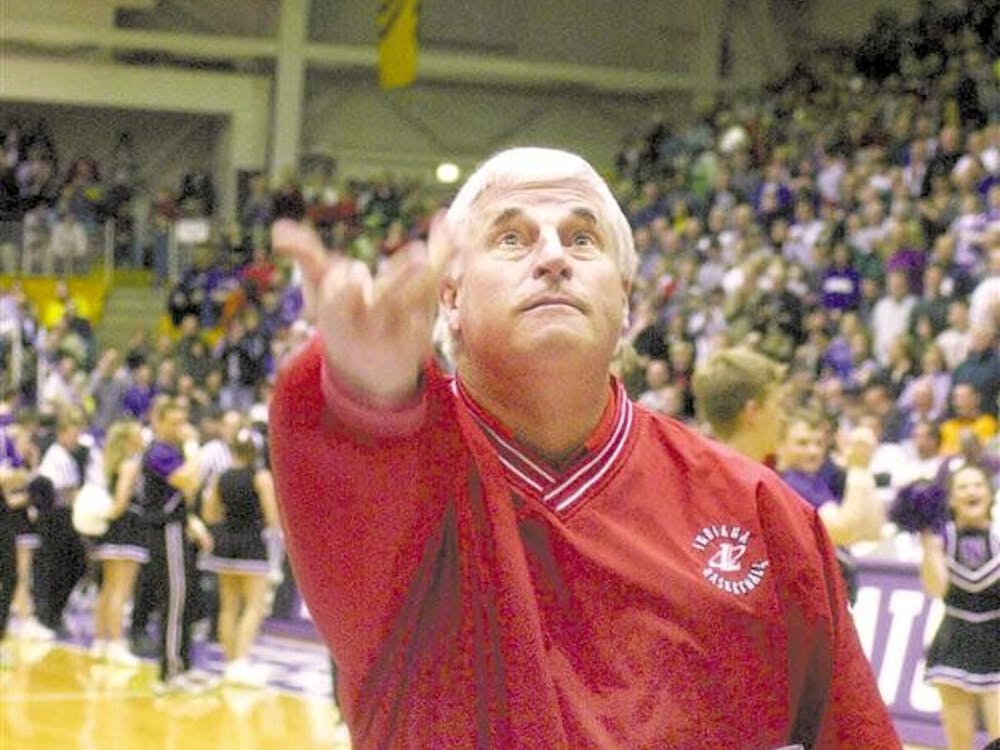 Indiana coach Bob Knight tosses candy to the Northwestern crowd as he enters the court at Welsh-Ryan Arena in Evanston, Ill., Saturday, Feb. 5, 2000. Knight and the NU fans have a tough relationship. Last year Knight and NU coach Kevin O'Neill had angry words after fans kept yelling "Who's your Daddy?" to Knight. 