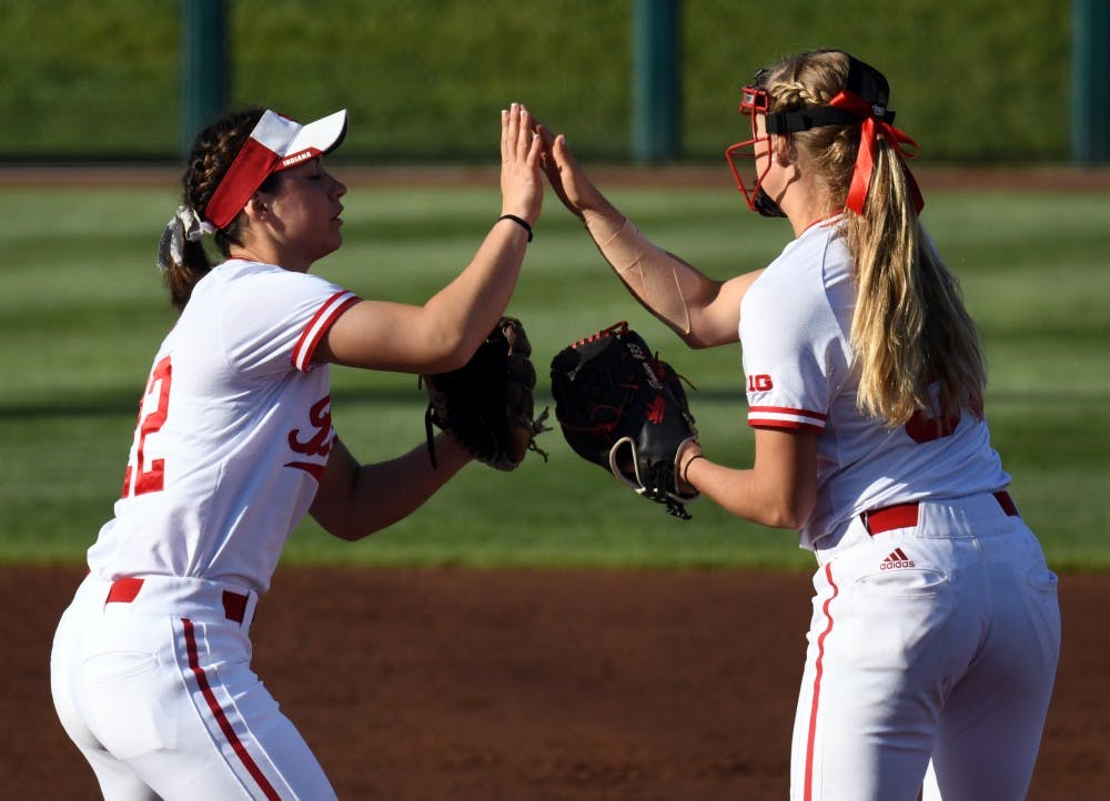 <p>Sophomore utility player Katie Lacefield and junior pitcher Tara Trainer high-five during the Hoosiers' game against Michigan on April 27 at Andy Mohr Field. IU will face Illinois in the Big Ten Tournaments quarterfinals Friday.</p>