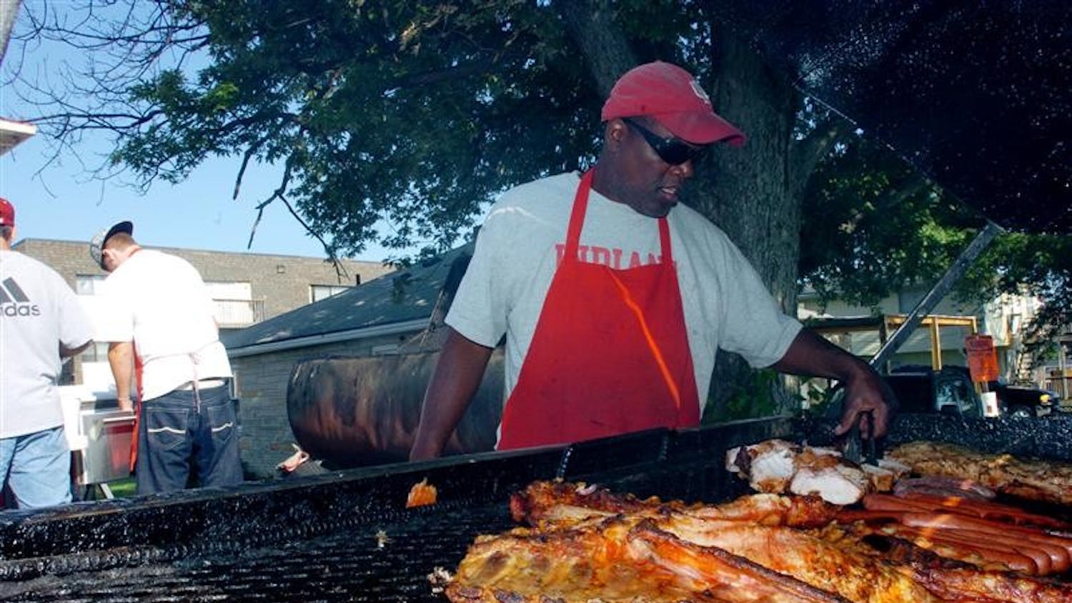 Will Thomas turns some meat on his grill prior to a football game between IU and Western Kentucky on Aug. 30 near Memorial Stadium.