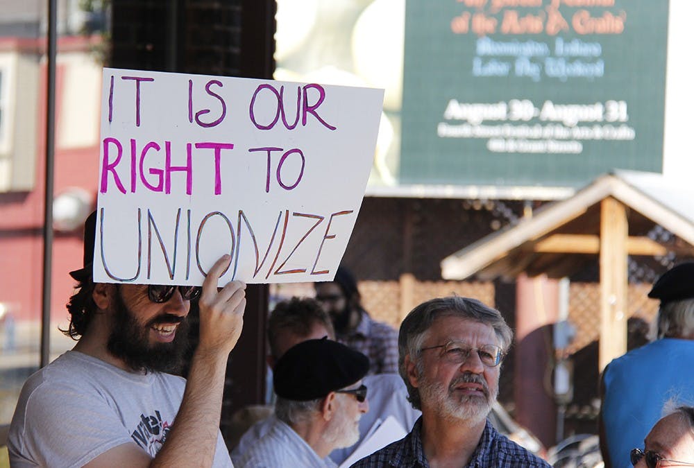 Protestors display signs and pass out flyers in order to educate in order to educate people who pass by about their mission to create a union for Bloomingfoods employees. 
