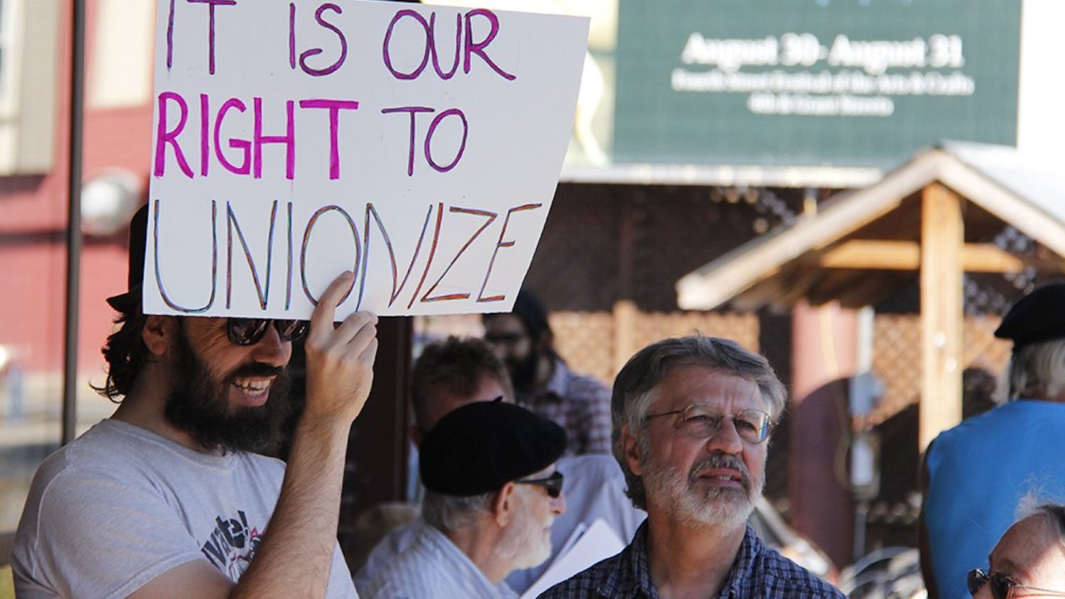 Protestors display signs and pass out flyers in order to educate in order to educate people who pass by about their mission to create a union for Bloomingfoods employees.