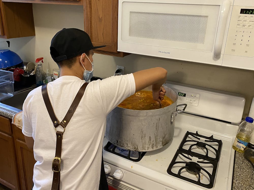 Community volunteer Jessie Wang helps prepare food for the striking graduate workers April 13, 2022, in the kitchen of the Canterbury house on IU’s campus. They said they felt it was important to get involved because a lot of the graduate workers struggle to afford food, and they saw an opportunity to help.