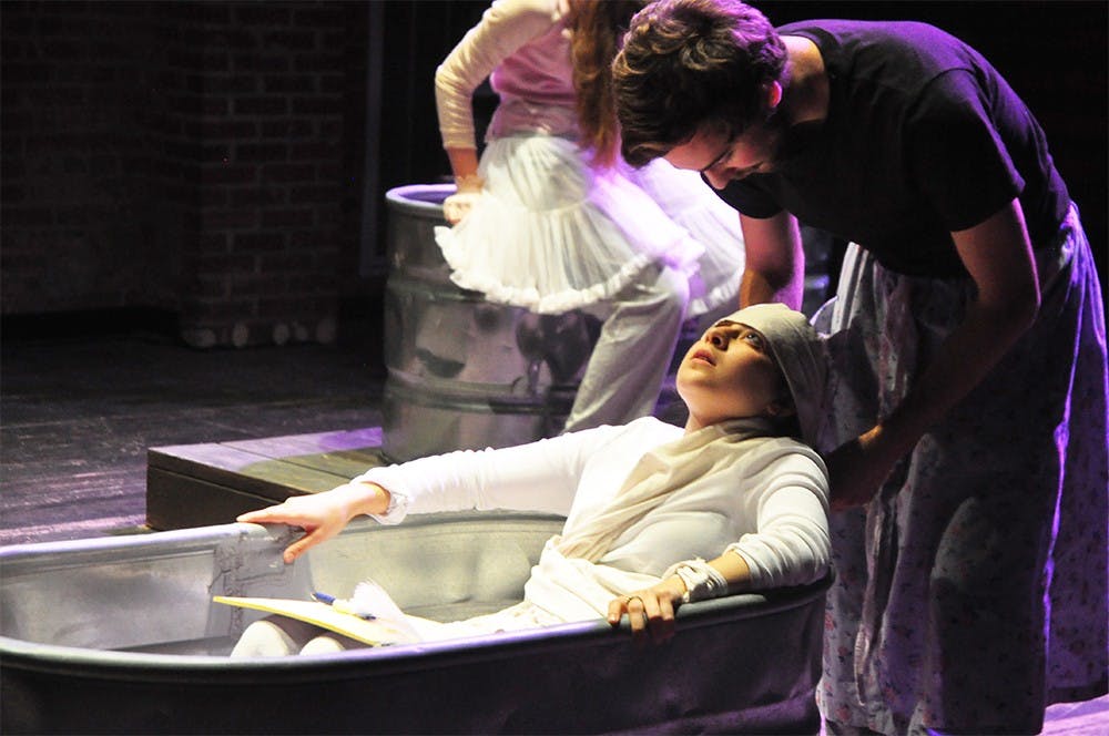 Junior Stephanie Feeley, left, and senior Matthew Martin, rehearse their roles in the play, Marat/Sade. The play will make its debut February 18. 