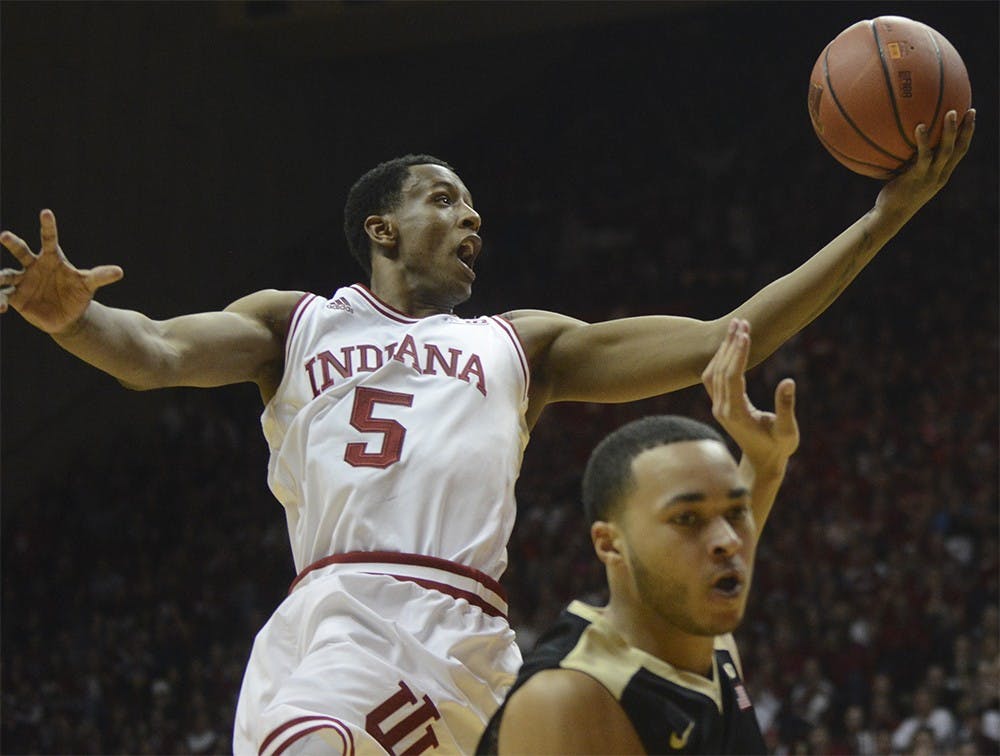 Junior forward Troy Williams shoots a layup past Purdue guard Kendall Stephens on Saturday at Assembly Hall. The Hoosiers won 77-73.