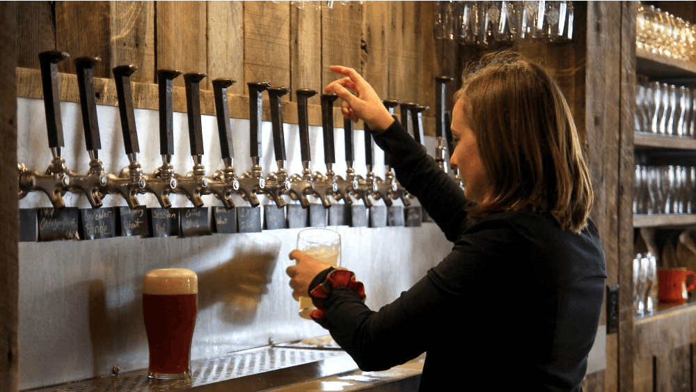 Emily Anderson pours drinks behind the bar at Switchyard Brewing Company, located on North Walnut Street. Switchyard was founded in 2014.&nbsp;