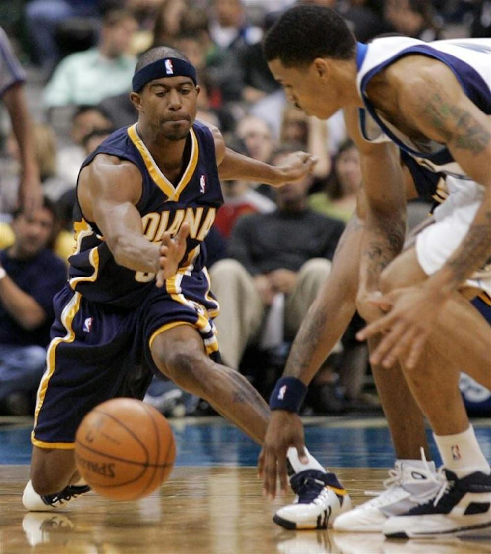 Indiana Pacers guard T.J. Ford, left, and Dallas Mavericks guard Gerald Green reach for a loose ball in the second half of a preseason NBA basketball game on Thursday in Dallas. The Pacers won 114-91.