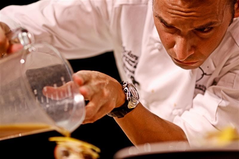 Chef Jake Branchley pours his sauce on his entrees before presenting them to the judges for the 2008 Bloomington Chef's Challenge Friday evening at the Buskirk-Chumley Theater. Proceeds for the event go to the Community Kitchen of Monroe County.