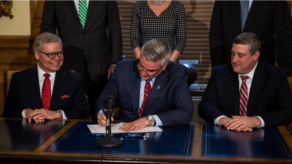 Gov. Eric Holcomb signs Senate Bill 1, which legalizes carryout sales of alcohol on Sundays. Since the 2018 legislative session has ended, Holcomb has signed several bills into law, including one that would allow Deferred Action for Childhood Arrivals recipients to pursue and receive professional licenses.