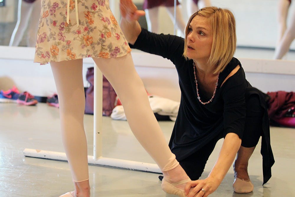 Jennifer Adam Bailey, a faculty member with the pre-college ballet program, corrects a student during class in the Musical Arts Center on Monday .  