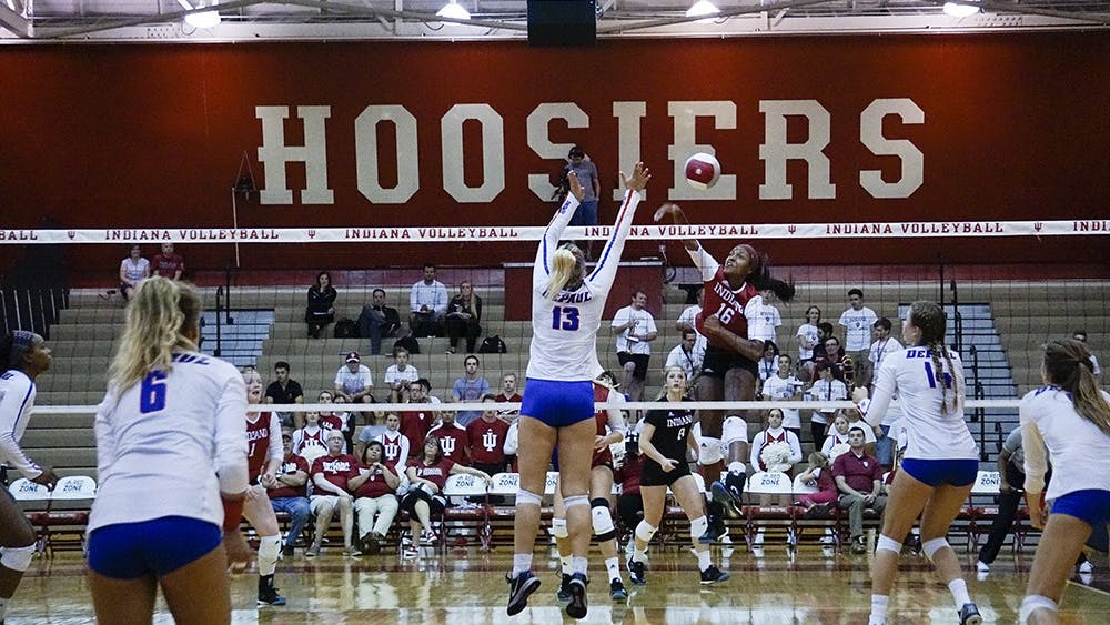 Sophomore Deyshia Lofton (16) spikes the ball for a kill leading the Hoosiers to their second win against DePaul University in August. IU women's volleyball will aim for its first conference win Wednesday night against Iowa.