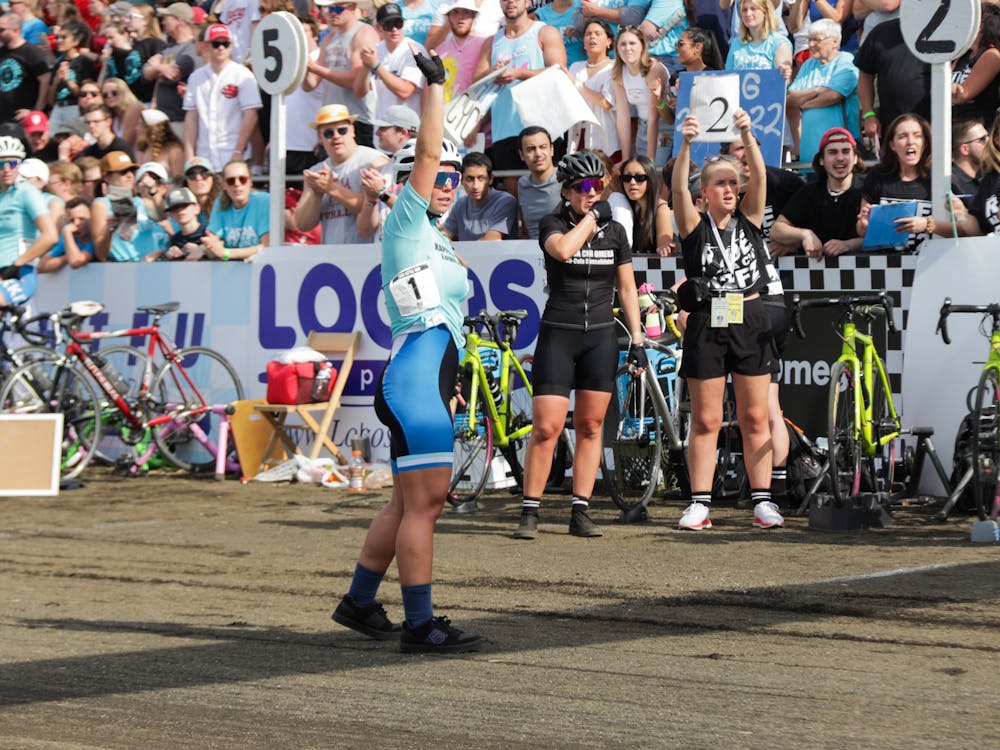 A member of Kappa Kappa Gamma's cycling team waits in the pit for her team member on April 22, 2022, at Bill Armstrong Stadium. Every team had fans in the stands behind their pit. 