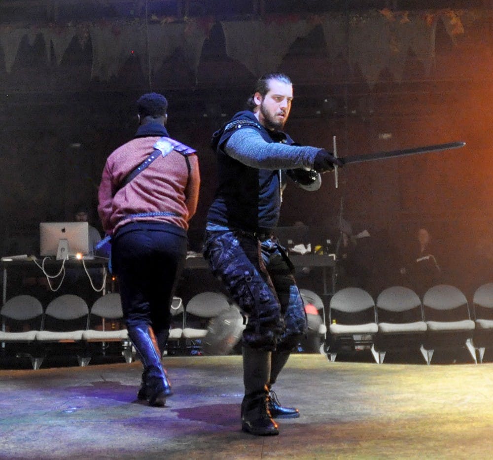 Senior Ian Martin, left, and John Putz play their parts during a rehearsal of Macbeth Tuesday at Wells-Metz Theatre.  