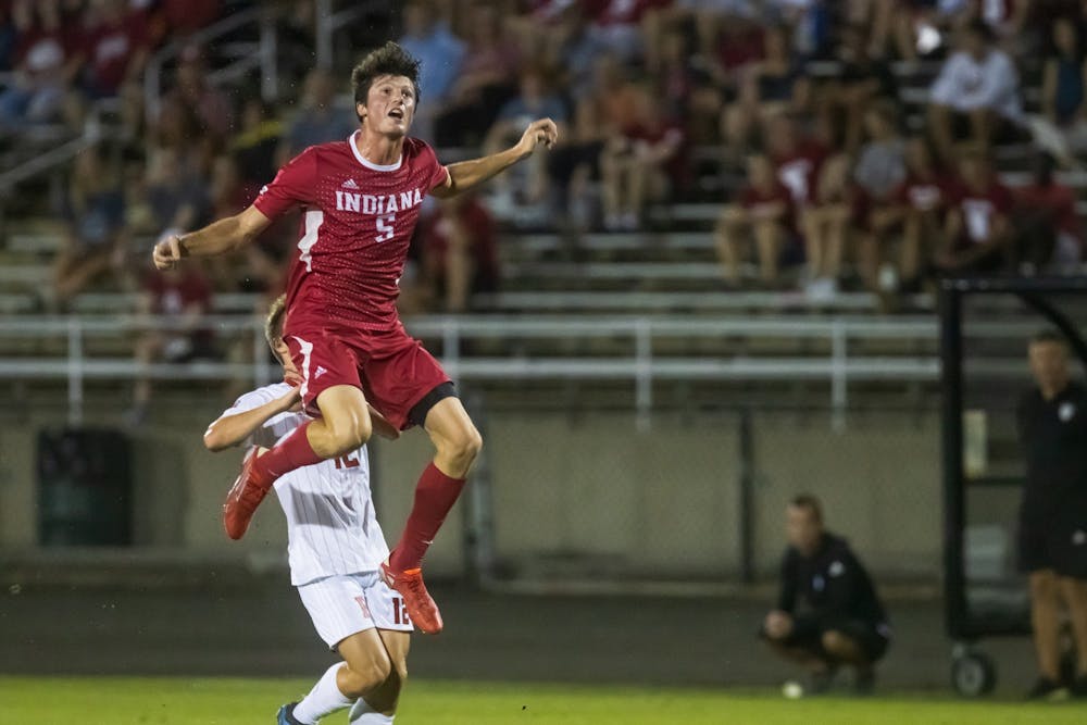 <p>Redshirt-junior defender Daniel Munie jumps for the ball Sept. 17, 2021 at Bill Armstrong Stadium. Rutgers defeated Indiana 2-1.</p>