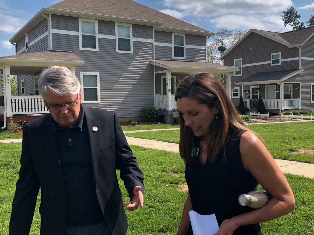 Bloomington Mayor John Hamilton and Habitat for Humanity of Monroe County Chief Executive Officer Wendi Goodlett chat at the ceremony in Habitat&#x27;s Trail View neighborhood Wednesday  announcing the partnership between the City and HFHMC to launch Osage Place. The neighborhood will create about 50 affordable homes.